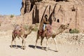 Petra, Jordan Ã¢â¬â December 25th, 2015: Bedouin man riding a camel Royalty Free Stock Photo